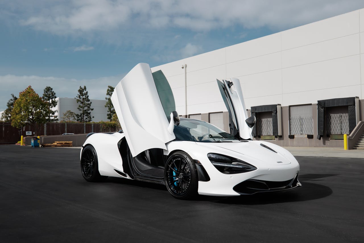 Dynamic white supercar with open doors showcasing elegance and modern design.